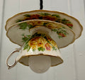 Teacup-shaped lamp with floral design on a white background