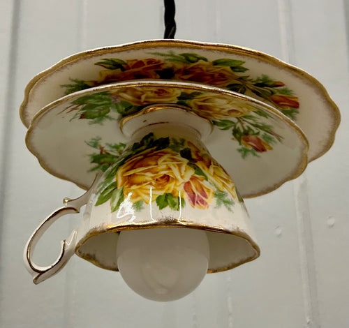 Teacup-shaped lamp with floral design on a white background